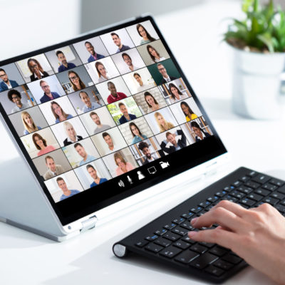 Man Working From Home Having Online Group Videoconference On Laptop